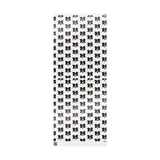 Black and white dog patterned wrapping paper sheet uncureled on a white background