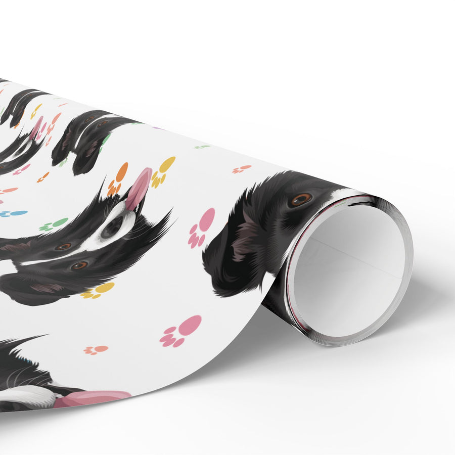 A roll of wrapping paper featuring a playful black and white dog face pattern with colorful paw prints, shown partially unrolled on a clean white background.