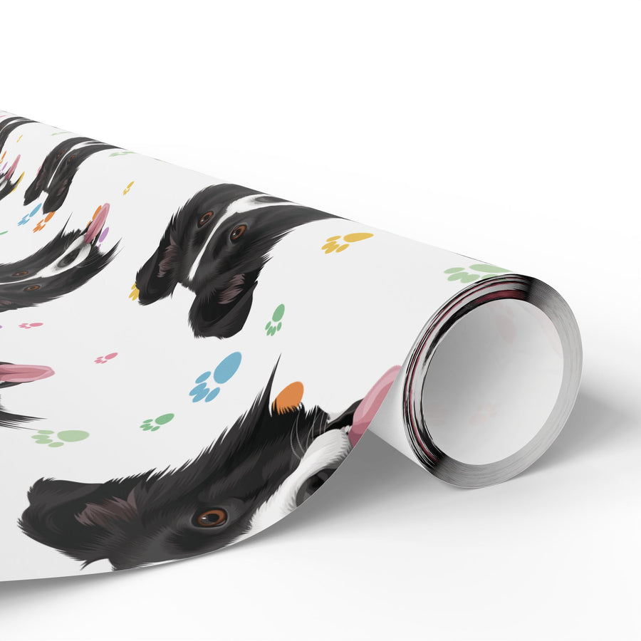 A roll of wrapping paper featuring a playful pattern of black and white dog head and colorful paw prints, shown on a clean white background.
