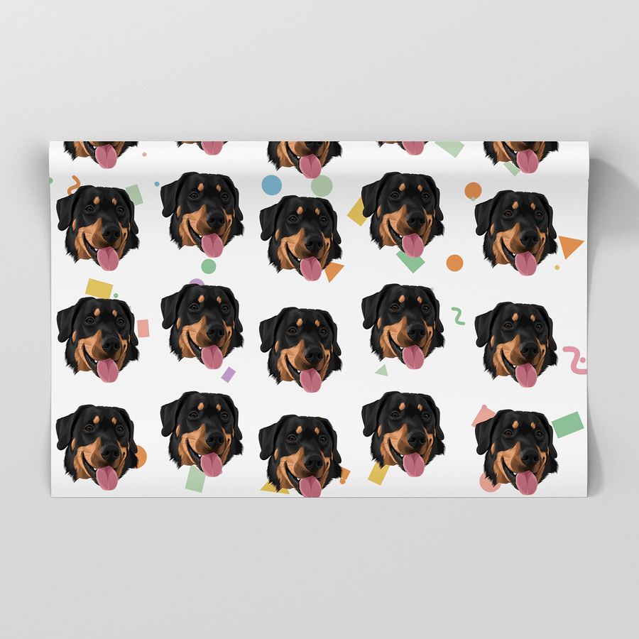 A rectangular sheet of wrapping paper featuring a repeating pattern of illustrated Rottweiler dog faces with colorful confetti accents on a white background, shown against a light gray backdrop.